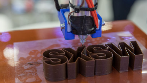 A 3D printer creating the SXSW logo at the Austin conference. Photo by Cal Holman, courtesy of SXSW